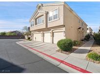 Attractive townhome with three-car garage and well-kept landscaping and ample parking at 4675 Color Up Ct # 101, Las Vegas, NV 89122