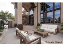 Inviting front porch featuring an outdoor seating area and a view of the home's grand entrance at 5210 Villa Dante Ave, Las Vegas, NV 89141