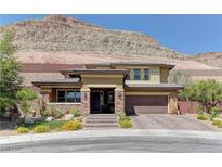 Stunning two-story home featuring a desert landscape and a charming stone and stucco exterior at 5635 Mesa Mountain Dr, Las Vegas, NV 89135