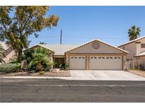 Charming single-story home featuring a two-car garage and well-maintained landscaping at 5824 Kane Holly St, Las Vegas, NV 89130