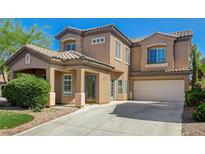 Inviting two-story home boasting a tile roof, manicured lawn, and an attached two-car garage at 5931 Allanche Ave, Las Vegas, NV 89141