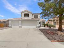 Two-story home featuring a three-car garage and desert landscaping at 6120 Desert Haven Rd, Las Vegas, NV 89130