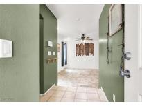 Inviting entryway featuring neutral paint, tile flooring, and an open floor plan leading into the spacious living area at 6581 Netherseal Ave, Las Vegas, NV 89139