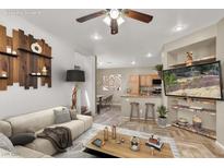 Bright living room with a ceiling fan, rustic wooden decor, and view of kitchen at 6581 Netherseal Ave, Las Vegas, NV 89139