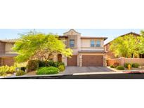 Charming two-story home featuring a paved driveway, manicured landscaping, and a two-car garage at 749 Middle Beach St, Las Vegas, NV 89138