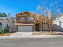 Charming two-story home featuring a classic design with a red tile roof and an attached two-car garage at 8733 Country Pines Ave, Las Vegas, NV 89129
