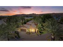 Stunning exterior view of a desert home with lush palm trees and a beautiful sunset sky at 1 Via Mira Monte, Henderson, NV 89011