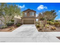 Charming two-story home with a well-maintained front yard and a two-car garage at 1104 Aspen Cliff Dr, Henderson, NV 89011