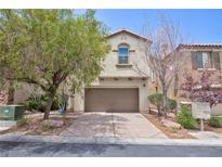 Charming two-story home featuring an attached two-car garage and mature landscaping at 11221 Victoria Medici St, Las Vegas, NV 89141