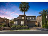 Beautiful two-story home with stone accents, a tile roof, and lush landscaping at 11503 Glowing Sunset Ln, Las Vegas, NV 89135