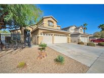 Charming two-story home features a three car garage, desert landscaping and secure wrought iron gate at 1740 Flores Ln, Henderson, NV 89012