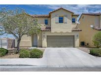 Charming two-story home with a neutral color scheme, desert landscaping, and an attached two-car garage at 1952 W Hammer Ln, North Las Vegas, NV 89031