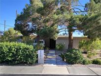 Charming single-story home with mature trees and landscaping creating curb appeal at 2001 E Mcwilliams Ave, Las Vegas, NV 89101