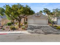 Charming single-story home featuring a well-manicured front yard, mature trees, and a two-car garage on a sunny day at 2158 Shubert Ave, Henderson, NV 89052