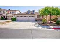 Charming single-story home featuring a two-car garage and well-manicured landscaping at 270 New River Cir, Henderson, NV 89052