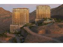 An exterior view showcasing two modern high-rise buildings nestled in a scenic desert landscape at 410 Rock Peak Dr # 1704, Henderson, NV 89012