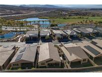 An aerial view showing homes in a community with a nearby golf course and water features at 44 Alta Cascata Pl, Henderson, NV 89011