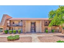 Inviting condo complex with well-maintained landscaping, stone accents, and a red tile roof at 5021 River Glen Dr # 45, Las Vegas, NV 89103