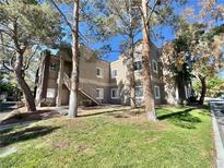 Attractive condo complex with mature trees and well-maintained landscaping at 5250 S Rainbow Blvd # 2029, Las Vegas, NV 89118