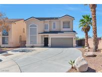 Inviting two-story home showcasing a well-maintained yard and ample driveway space at 5341 Cool Dawn Ct, Las Vegas, NV 89130