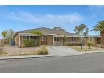 Charming single-story home with neutral exterior, xeriscape landscaping, and covered porch at 603 Palmhurst Dr, Las Vegas, NV 89145