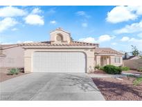 Single story home featuring desert landscaping, a two car garage, and a light colored exterior at 6231 Curlew Dr, Las Vegas, NV 89122