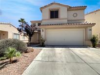 Charming two-story home featuring a two-car garage and desert landscaping in a sunny neighborhood at 7900 Wood Shadow Ct, Las Vegas, NV 89131