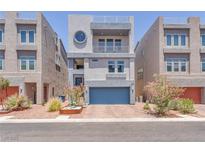 Modern, three-story home features a blue garage door and stylish architectural details at 8076 Haywood Estate Ave, Las Vegas, NV 89113