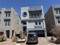Contemporary two-story home featuring a balcony, rooftop terrace, and a convenient attached two-car garage at 8076 Haywood Estate Ave, Las Vegas, NV 89113