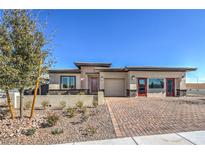 Charming single-story home with a brick driveway and desert landscaping at 1044 Forest Falcon Dr, Henderson, NV 89011