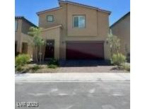 Inviting two-story home boasting a modern design with a two-car garage and easy-care landscaping at 1885 Vass Springs Pl, North Las Vegas, NV 89084