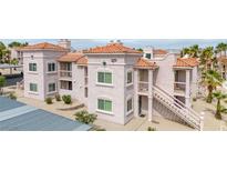 Inviting condo featuring balconies, terracotta tile roof, mature trees, and ample parking spaces at 1944 Las Palmas Ln # 174, Laughlin, NV 89029