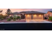 Charming single-story home featuring a well-manicured front yard, desert landscaping and a two-car garage at 20 Kittansett Loop, Henderson, NV 89052