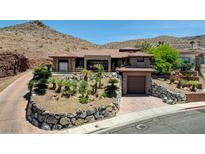 Stunning single-story home nestled in the hills with desert landscaping and an attached garage at 205 Red Rock Rd, Boulder City, NV 89005