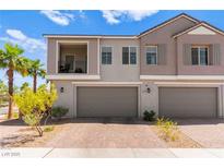 Charming townhome featuring a private balcony and two-car garage, enhanced by lush palm trees and desert landscaping at 295 Callen Falls Ave # 2225, Henderson, NV 89011