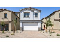 Inviting two-story home with a neutral color palette, a brick driveway, and a two-car garage at 336 Taylor St, Henderson, NV 89015
