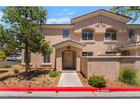Charming condo featuring a covered entryway, neutral stucco exterior and well-maintained landscaping at 3950 S Sandhill Rd # 130, Las Vegas, NV 89121