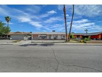 Charming single-story home with a gravel yard and mature palm trees at 4067 E Colorado Ave, Las Vegas, NV 89104
