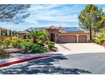 Charming single-story home with a three-car garage and well-manicured front yard landscaping at 4196 Balmoral Castle Ct, Las Vegas, NV 89141
