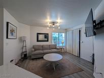 Inviting living room featuring modern lighting, neutral tones, and a comfortable seating arrangement at 460 Elm Dr # 103, Las Vegas, NV 89169