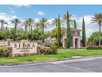 Landscaped entrance to Siena Golf Club & Bistro, featuring manicured lawns, colorful flowers, and towering palm trees at 4845 Santo Romeo St, Las Vegas, NV 89135