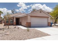 Inviting single story home featuring low-maintenance desert landscaping and attached two car garage at 5043 Naff Ridge Dr, Las Vegas, NV 89131