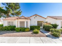 Charming single-story home with a tile roof and well-maintained landscaping with mature trees and gravel ground cover at 5424 Comchec Way # 105, Las Vegas, NV 89108