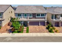 Charming two-story home featuring a stone facade, three-car garage, and a beautifully landscaped front yard at 7260 Grace Estate Ave, Las Vegas, NV 89113
