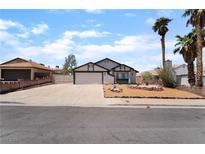Charming single-story home with a two-car garage and a landscaped front yard with desert landscaping at 806 Fireweed Dr, Henderson, NV 89002