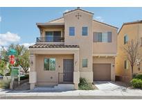 Charming two-story home boasts neutral stucco exterior and covered porch entry at 9053 Entrancing Ave, Las Vegas, NV 89149