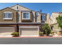 Townhouse shows brick accents and attached garages for convenient parking at 939 Paisley St, Las Vegas, NV 89145