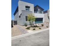Modern two-story home with a minimalist design, desert landscaping, and a two-car garage at 10021 Locking Biner Ave, Las Vegas, NV 89166