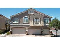 Charming two-story home with a three-car garage, balcony and neutral exterior color scheme at 1073 Pleasure Ln # 2, Henderson, NV 89002