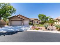 Charming single-story home featuring a three-car garage, desert landscaping, and a tile roof at 1274 Doggett Ave, Las Vegas, NV 89123
